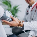 young-male-psysician-with-patient-measuring-blood-pressure_1303-17877